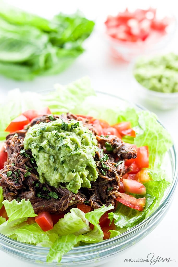Chipotle Copycat Barbacoa on top of lettuce and red peppers with guacamole